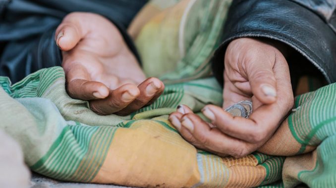 homeless-woman-holding-hands-out-help_23-2148760841